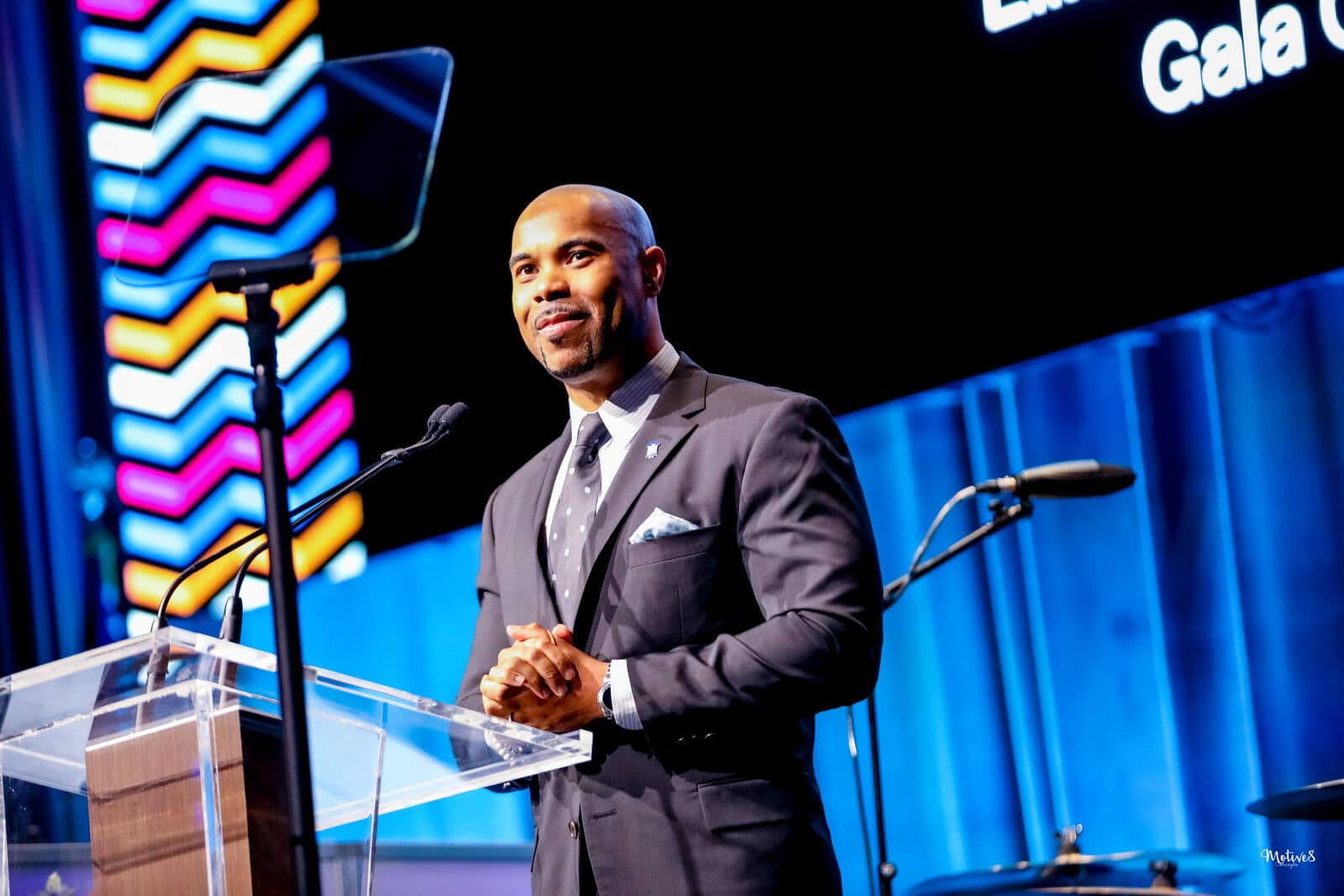 A speaker on stage at the 100/50 Gala